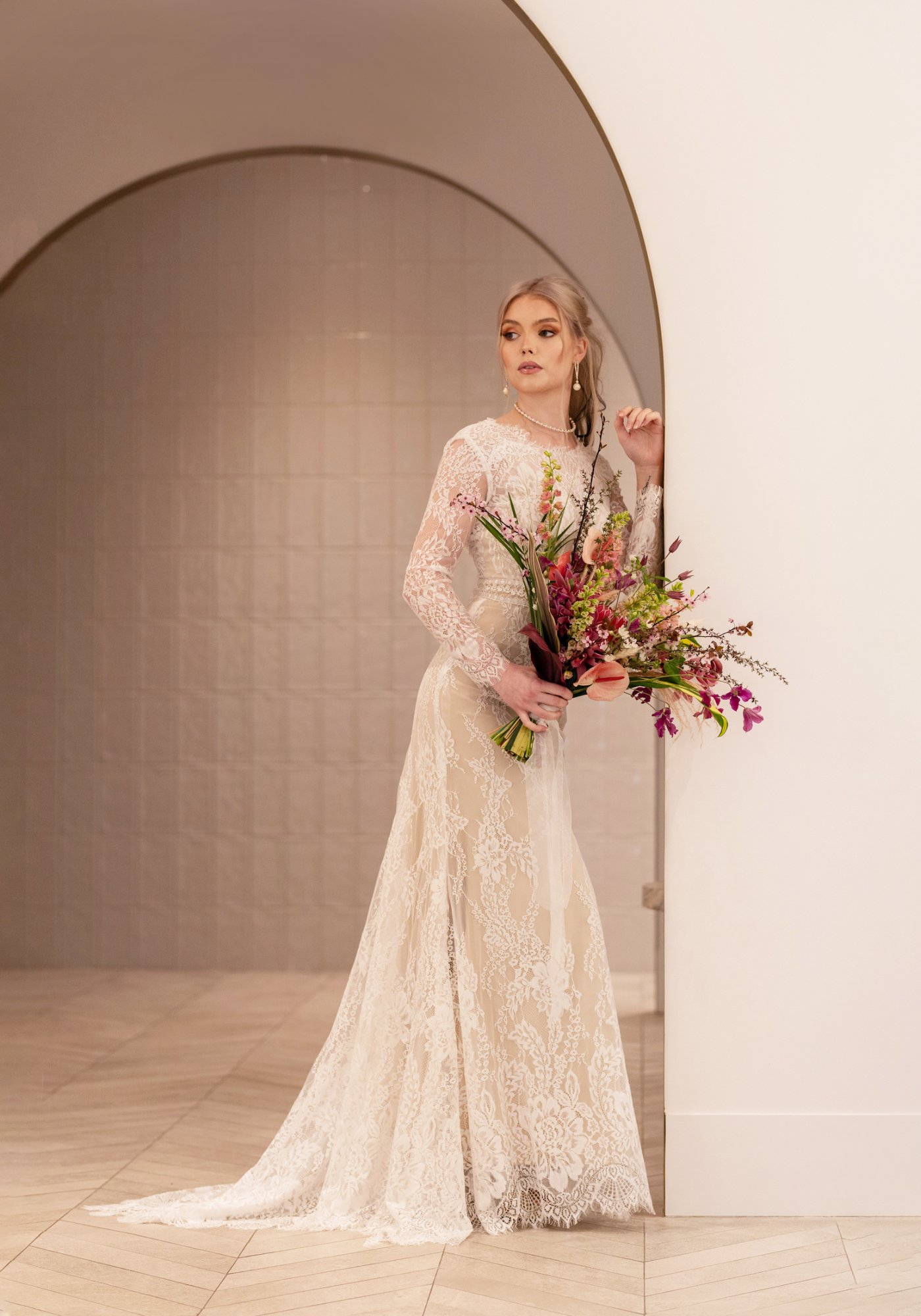 Romantic bridal updo with soft waves and floral accessories for Vancouver wedding