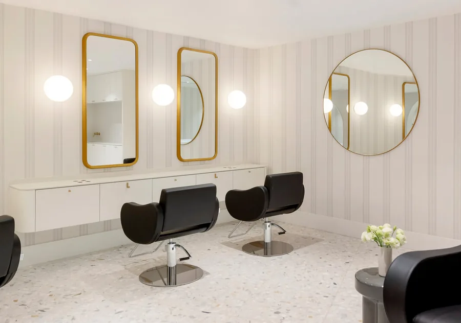 Styling stations with gold-framed mirrors at Wish Dry Bar inside the Fairmont Pacific Rim